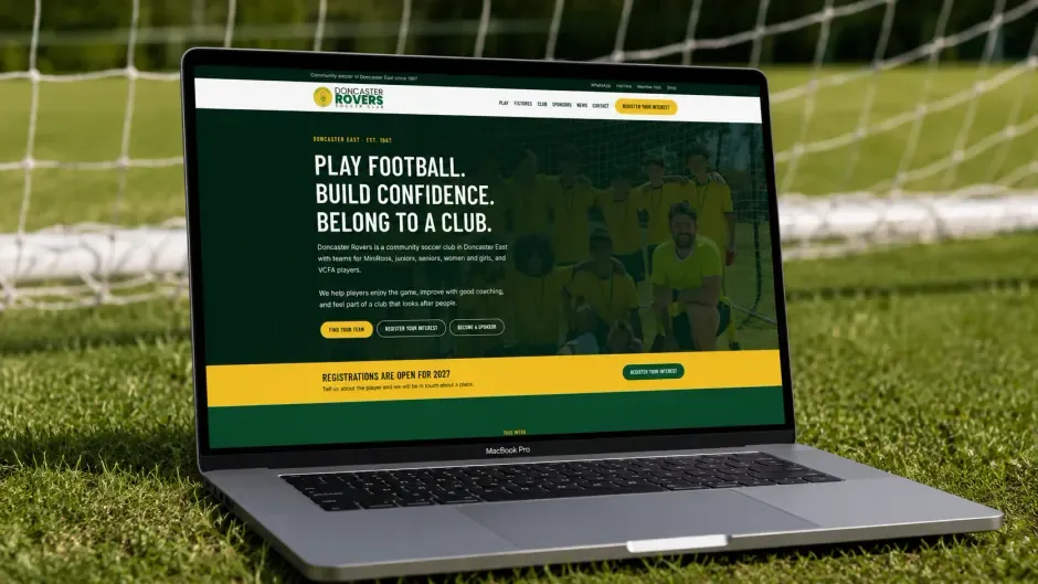 The Doncaster Rovers home page on a laptop, standing on the grass in front of a goal.