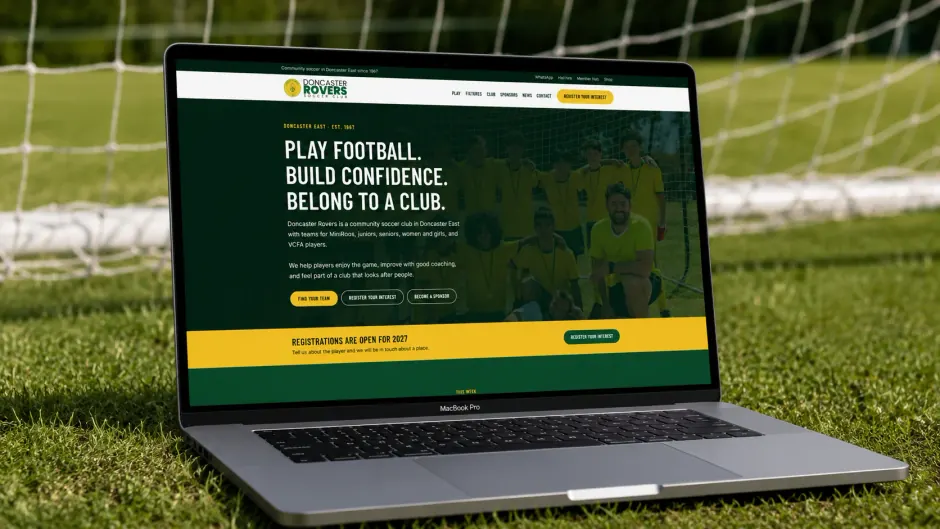 The Doncaster Rovers home page on a laptop, standing on the grass in front of a goal.